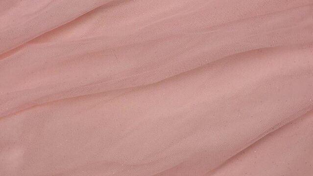 Soft Chiffon Detailed Texture. Natural Mesh Fabric Closeup Knit Pattern. Pink Light Polyester Surface. Rotation, Macro. Cozy Textile Background. Clothes Production. Melange Yarn. 4K Shot