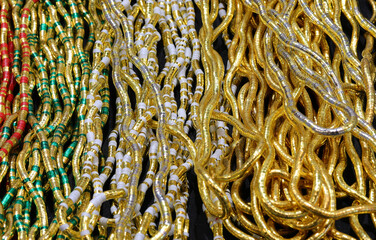 background of necklaces made with gold inserts and vibrant hues offering endless customization...