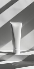 luxury minimalist square edged aluminium face cream tube with no label and soft pain grey backdrop