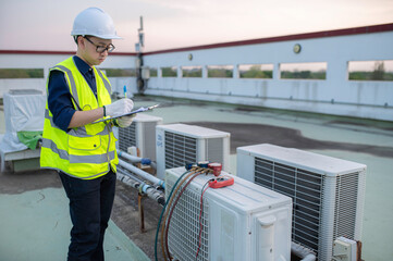 Refrigeration and Air Conditioning Engineering Detects Plant Cooling Problems,electrician maintenance Condensing on the rooftop outdoors of large industrial building,engineer under checking the indust