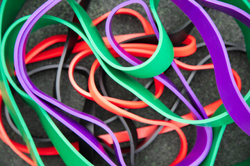 Sports equipment for pumping muscles . Background of colorful rubber elastic bands