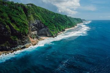 Mountain rocky landscape with coastline and turquoise ocean in Bali. Aerial view