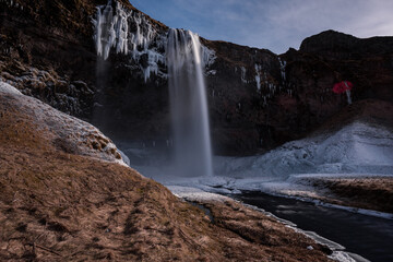 Snowy waterfall with ice
