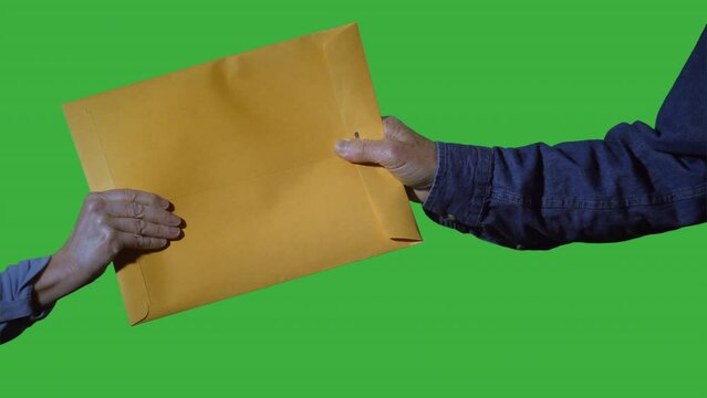 Man and woman handling a manila envelope green screen