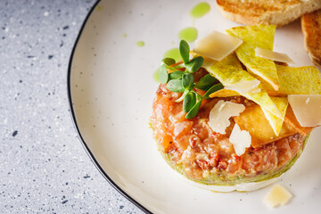 delicious fresh salmon tartar on a white plate