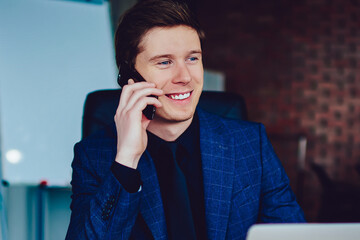 Smiling male manager calling to customer service for checking account balance feeling excited from...