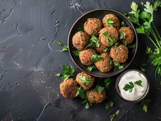 Top view of Egyptian falafel with tahini, using the rule of thirds, with ample copy space