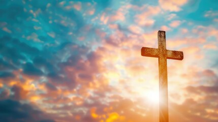 A striking Christian cross stands tall against a dazzling sunset backdrop creating a captivating image with space for text related to Christian faith and religion
