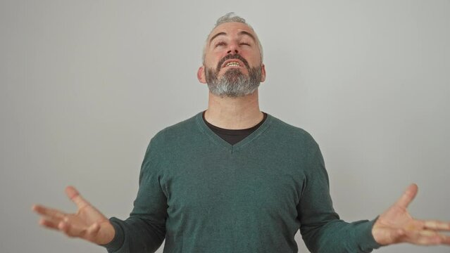 Enraged young man in sweater, screaming, shouting in anger, frustration; standoffish, furious expression on isolated white background