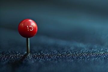 Red ball on a blue cloth with a small white dot