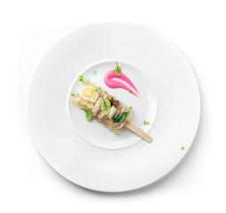 Delicious aspic or galantine with chicken meat, egg, greens and horseradish on plate isolated on white background. Healthy food, flat lay, top view