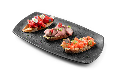 Delicious bruschetta with ham, bruschetta with salmon fish and bruschetta with baked bell pepper on...