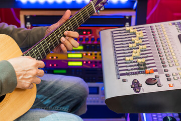 guitar recording concept. male musician playing guitar in home recording studio