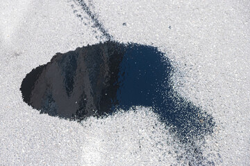 oil stain on a street due to a car breakdown