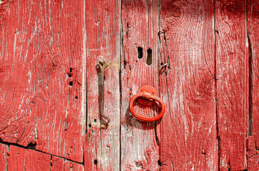 detail of an antique red painted wooden door
