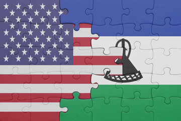 puzzle with the colourful national flag of lesotho and flag of united states of america .