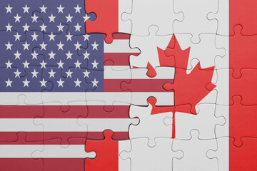 puzzle with the colourful national flag of canada and flag of united states of america .