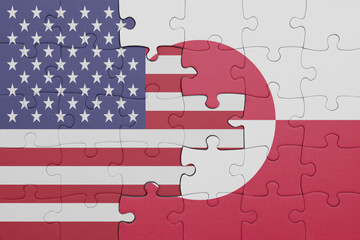 puzzle with the colourful national flag of greenland and flag of united states of america .