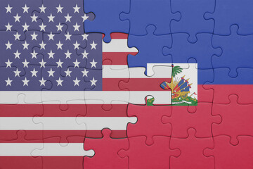 puzzle with the colourful national flag of haiti and flag of united states of america .