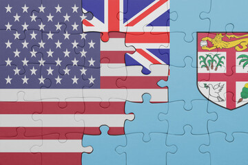 Obraz premium puzzle with the colourful national flag of Fiji and flag of united states of america .