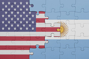 puzzle with the colourful national flag of argentina and flag of united states of america .