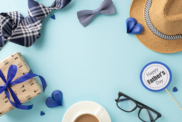 Festive Father's Day setup with a gift box, coffee mug, straw hat, and elegant ties on a soothing...