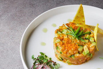 delicious fresh salmon tartar on a white plate