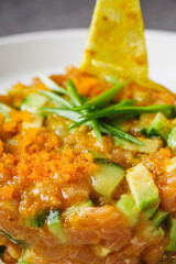 delicious fresh salmon tartar on a white plate