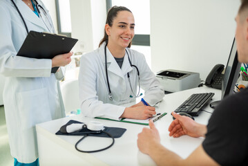 Compassionate doctor discussing treatment options with patient in bright clinic office