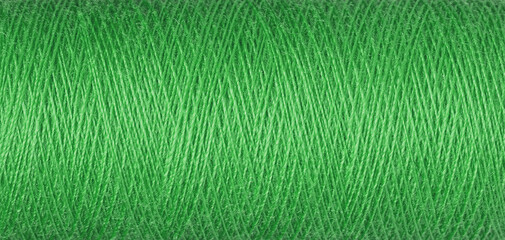 macro texture of a skein of green sewing thread