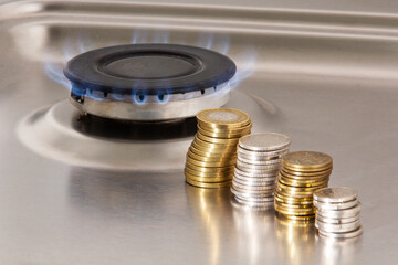 gas stove and coins on a gray background