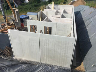 concrete walls to build a cellar at the construction site for a prefabricated family house.