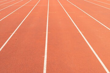 Fototapeta premium Synthetic track with white lines in the athletics stadium..