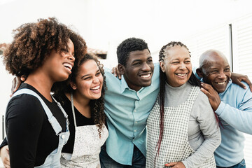 African family having fun hugging together. Happy Father, mother, daughters, brother making healthy...