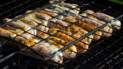 sausages in sauce, grilled on coals. outdoor picnics. barbecue and grill. delicious and healthy food