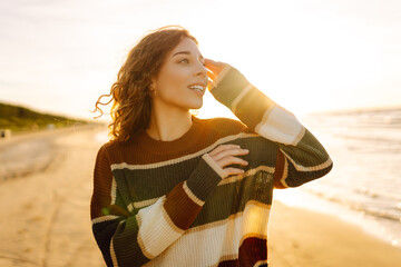 Young woman  enjoying serene ocean nature during travel holidays vacation at sunset. Travel,...