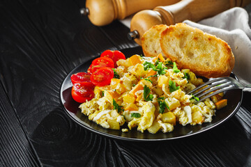 tasty scrambled eggs with zucchini on a black rustic rustic background