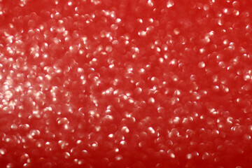 Shiny red background with glare and blurred bokeh . Festive glitter gradient. Christmas, New Year, Birthday, March 8, Valentine's and International Women's Day