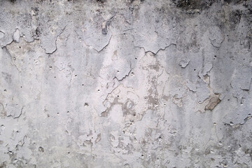 Peeling paint on grungy plaster wall.