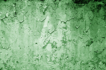 Peeling paint on grungy plaster wall. Green color.