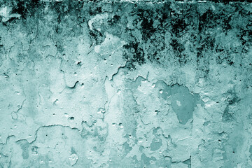 Grungy dirty plaster wall with peeling paint. Cyan color style.
