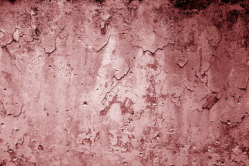 Peeling paint on grungy plaster wall. Red color.