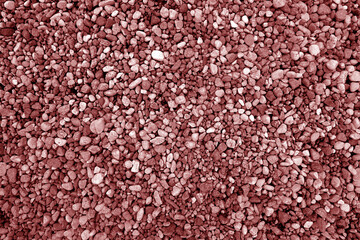 Pile of red color decorative pebblestones as background.