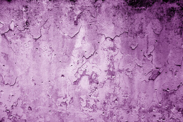 Peeling paint on grungy plaster wall. Purple color.