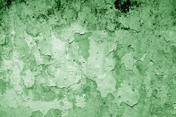 Peeling paint on grungy plaster wall. Green style.