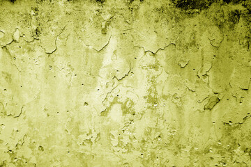 Peeling paint on grungy plaster wall. Yellow color.