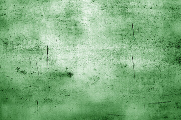 Scratched and weathered metal plate surface. Green toned