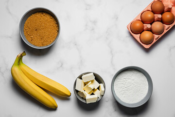 Baking banana bread, ingredients on marble background