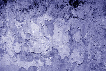 Peeling paint on grungy plaster wall. Deep blue style.