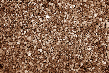 Pile of brown color decorative pebblestones as background.